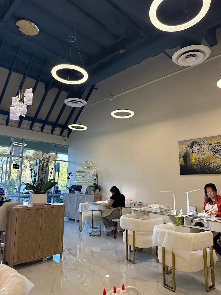 Modern salon interior with round pendant lights, staff at reception desk